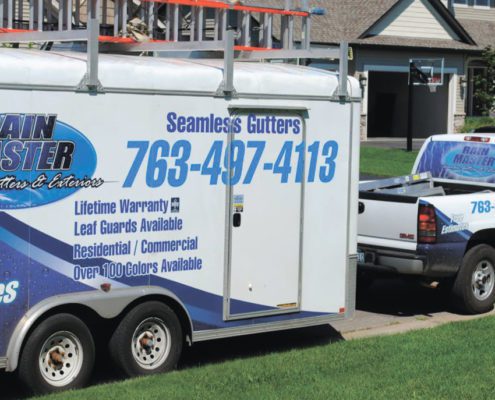 RainMaster-seamless-gutters white truck and trailer with Rain Master branding - Rain Master Seamless Gutters