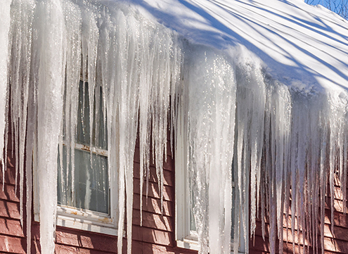 large icicles hanging from roof and gutters - Rain Master Seamless Gutters