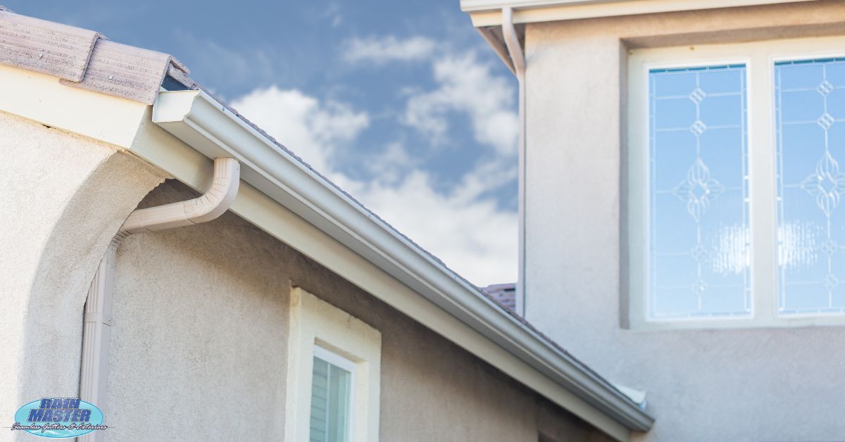 close up of white gutters on home - Rain Master Seamless Gutters