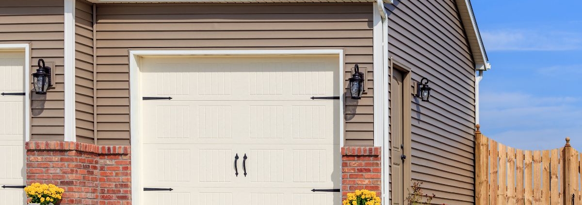 house with a white garage door with black accents - Rain Master seamless gutter installation near Clearwater