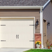 house with a white garage door with black accents - Rain Master seamless gutter installation near Clearwater