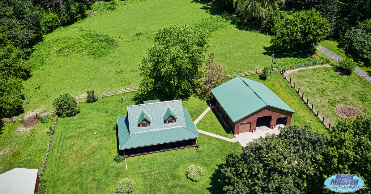 house with green roof on some land - Rain Master seamless gutter installation near Annandale