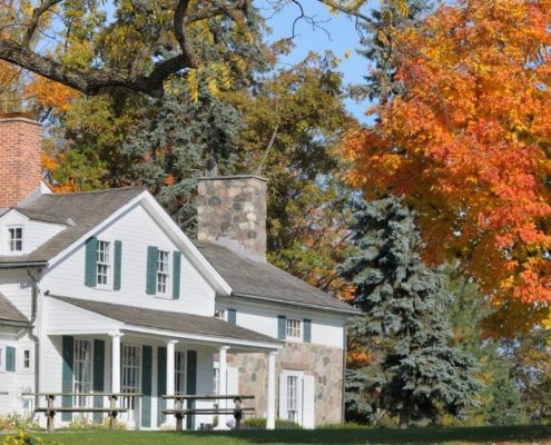 exterior of a home with multiple trees - Rain Master Seamless Gutters