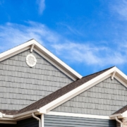 blue house with white gutters - Rain Master seamless gutter installation