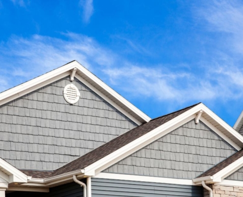 blue house with white gutters - Rain Master seamless gutter installation
