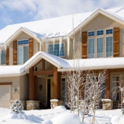 house with snow on roof and large icicles - Rain Master seamless gutters