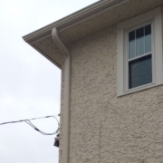house with stucco siding - Rain Master seamless gutter installation near Anoka