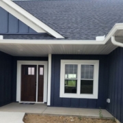 blue house with white seamless gutters - Rain Master seamless gutters