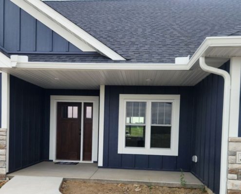 blue house with white seamless gutters - Rain Master seamless gutters