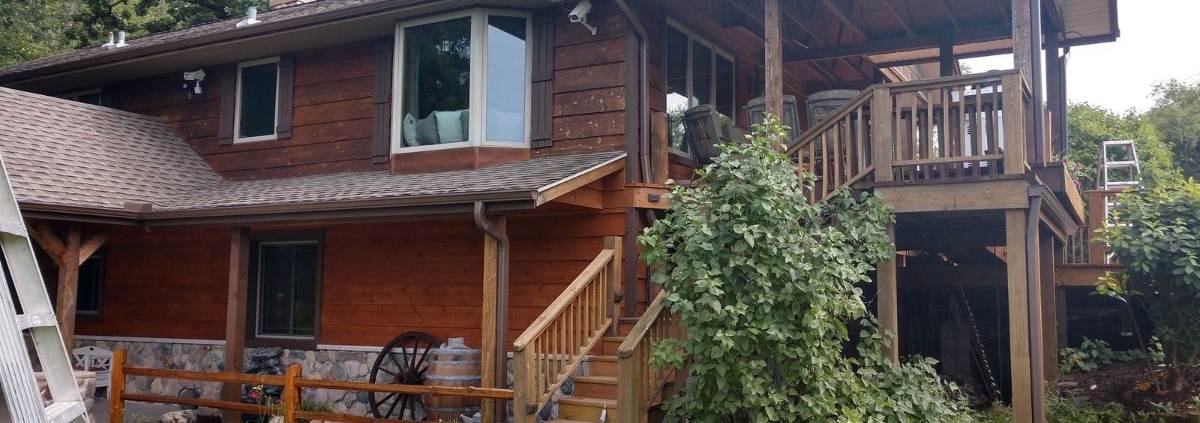 house with brown seamless gutters - Rain Master seamless gutters