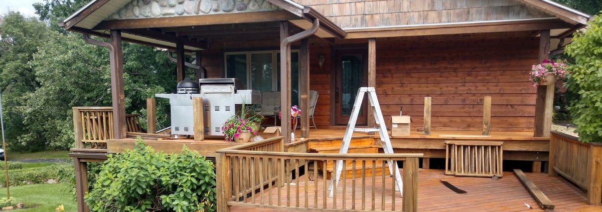 brown seamless gutters on a house with a front porch - Rain Master seamless gutter installation near Brooklyn Park