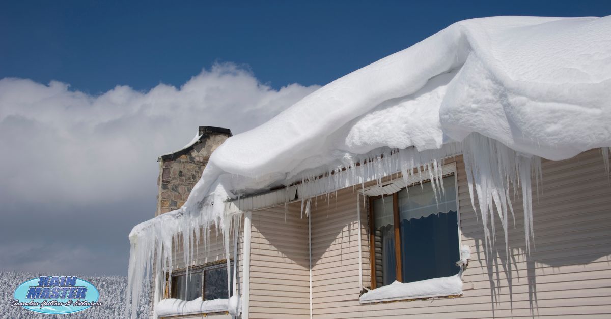 house with ice dams on roof - Rain Master seamless gutters