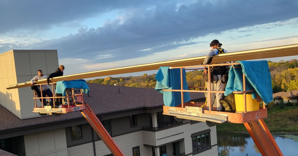 crew installing gutters to a building - Rain Master commercial gutter installation