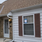 house with brown roof and brown shutters - Rain Master seamless gutters