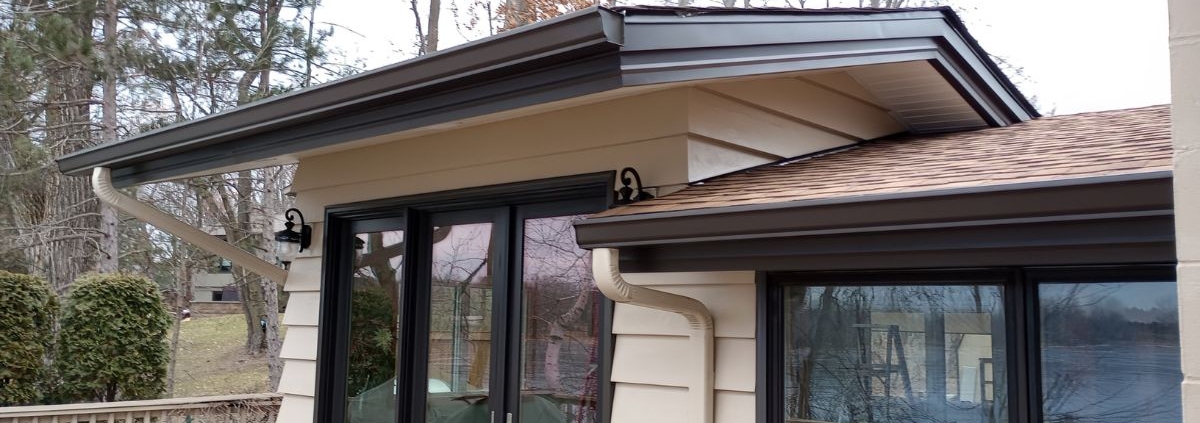 house beige siding and dark brown seamless gutters - Rain Master seamless gutter installation near Champlin