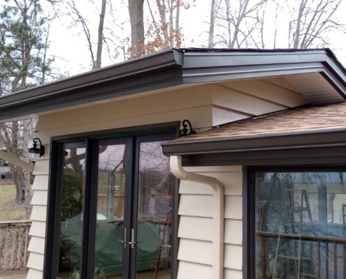 house beige siding and dark brown seamless gutters - Rain Master seamless gutter installation near Champlin