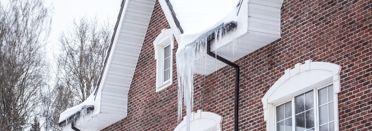 red brick house with ice dams - Rain Master seamless gutters Home Maintenance