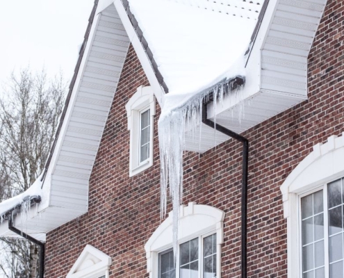 red brick house with ice dams - Rain Master seamless gutters Home Maintenance
