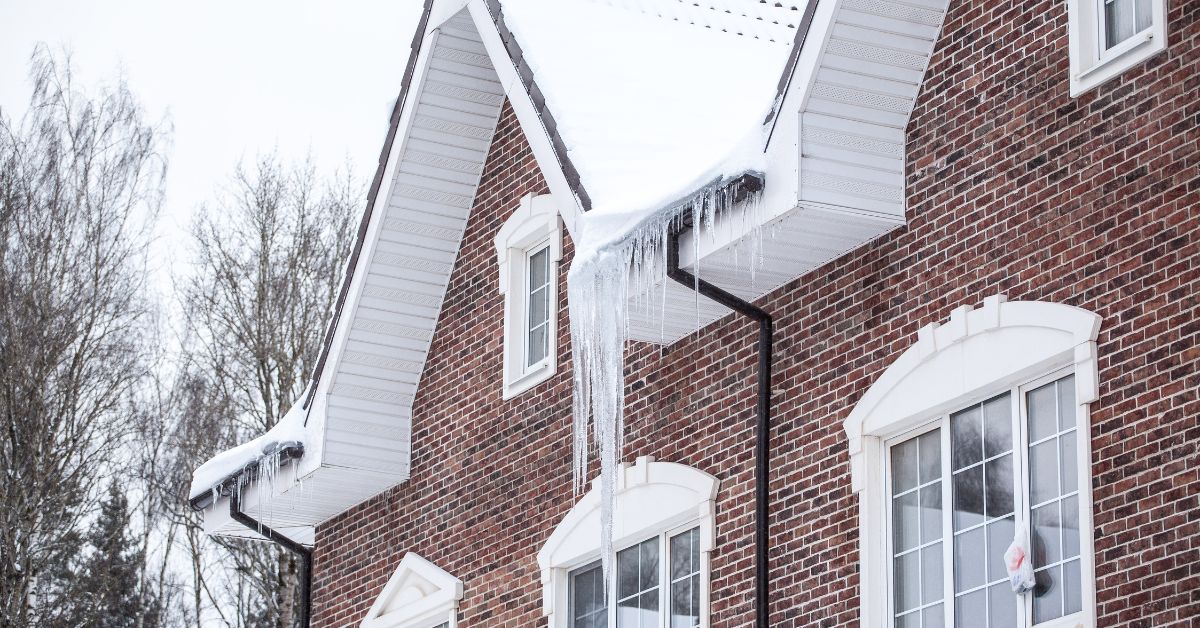 red brick house with ice dams - Rain Master seamless gutters