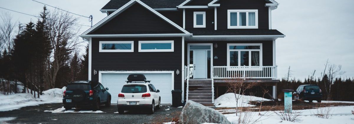 house in the winter with bright white trim work - Rain Master seamless gutters