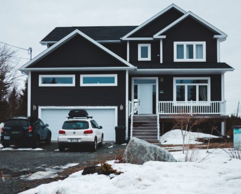 house in the winter with bright white trim work - Rain Master seamless gutters