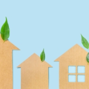 blue background with green leaves and paper cut outs of houses - Rain Master seamless gutters