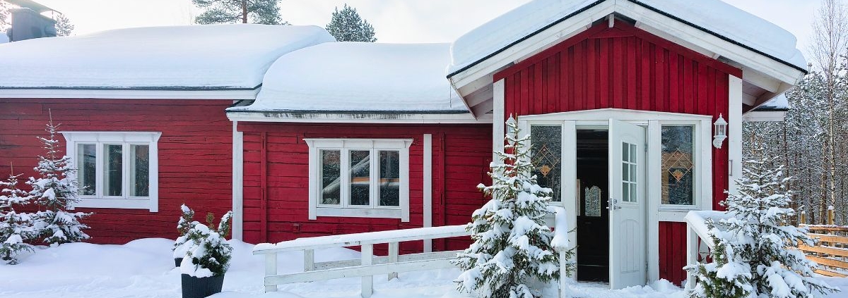 exterior of a red home in the winter - Rain Master Gutter Material