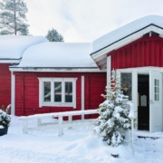 RainMaster-seamless-gutters-120420242 exterior of a red home in the winter - Rain Master Gutter Material