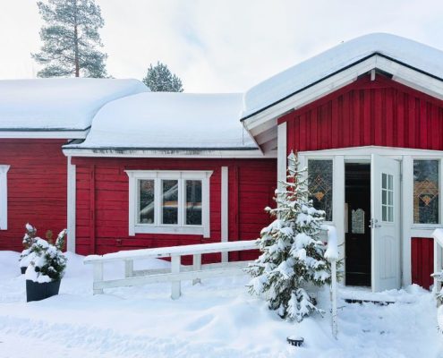 exterior of a red home in the winter - Rain Master Gutter Material