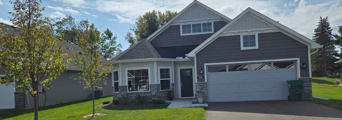 exterior of a two story home in the summer - Rain Master gutter installation