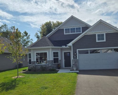 exterior of a two story home in the summer - Rain Master gutter installation