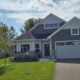 exterior of a two story home in the summer - Rain Master gutter installation