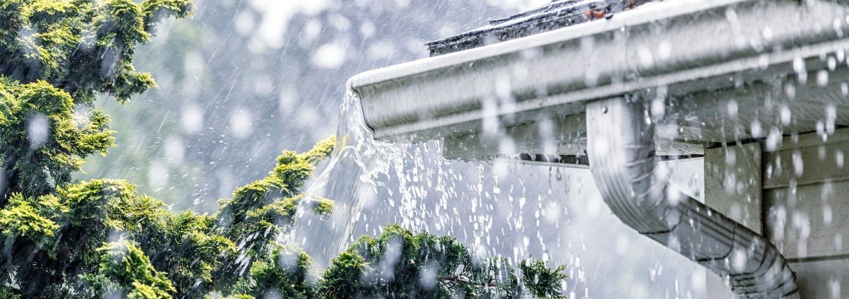 pouring rain with a focus on white gutters - Rain Master Seamless Gutters