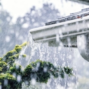 pouring rain with a focus on white gutters - Rain Master Seamless Gutters Gutter installers near St. Paul