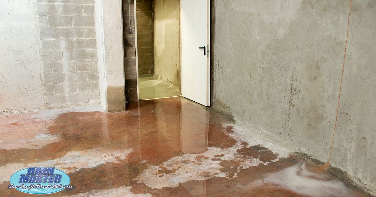basement with water pooling in - Rain Master seamless gutter installation
