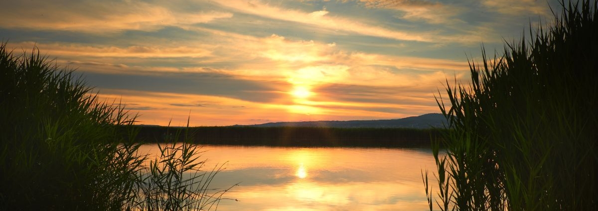 lake front during sunset -Rain Master Seamless Gutters seamless gutter installation near Centerville