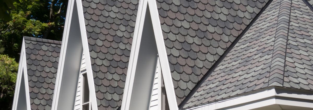 close up of a roof with grey shingles - Rain Master seamless gutter installation