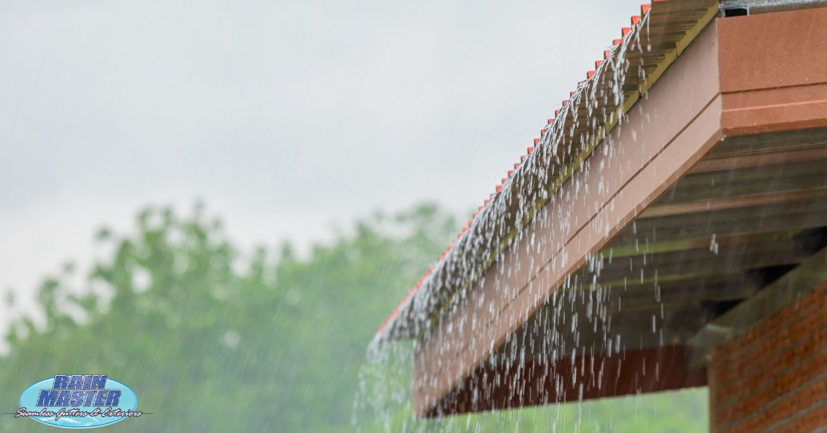 exterior of home roof during a rain storm - Rain Master seamless gutters