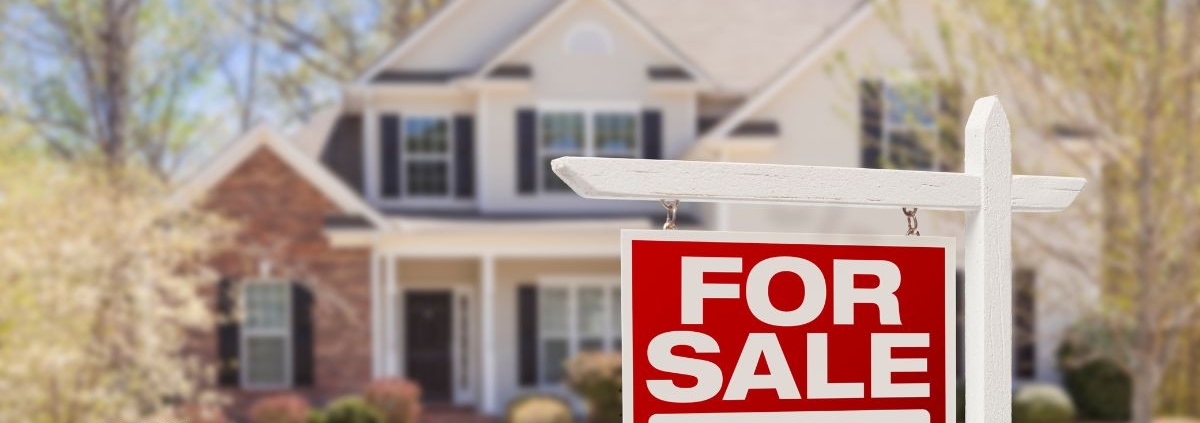 large two story home with a for sale sign out front - Rain Master seamless gutter installation