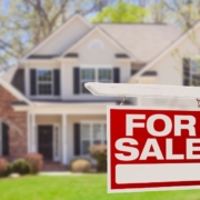 large two story home with a for sale sign out front - Rain Master seamless gutter installation
