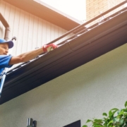 man installing gutters on a roof - Rain Master gutter installation