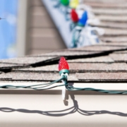 close up of multi colored holiday lights on gutters - Rain Master hanging Christmas lights