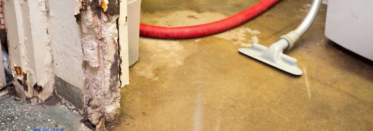 homeowner cleaning up water in their basement - Rain Master overflowing gutters