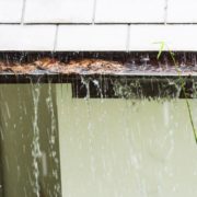 RainMasterSeamlessGutters-overflowing-gutters-050620261 overflowing gutters in a rain storm - Rain Master overflowing gutters